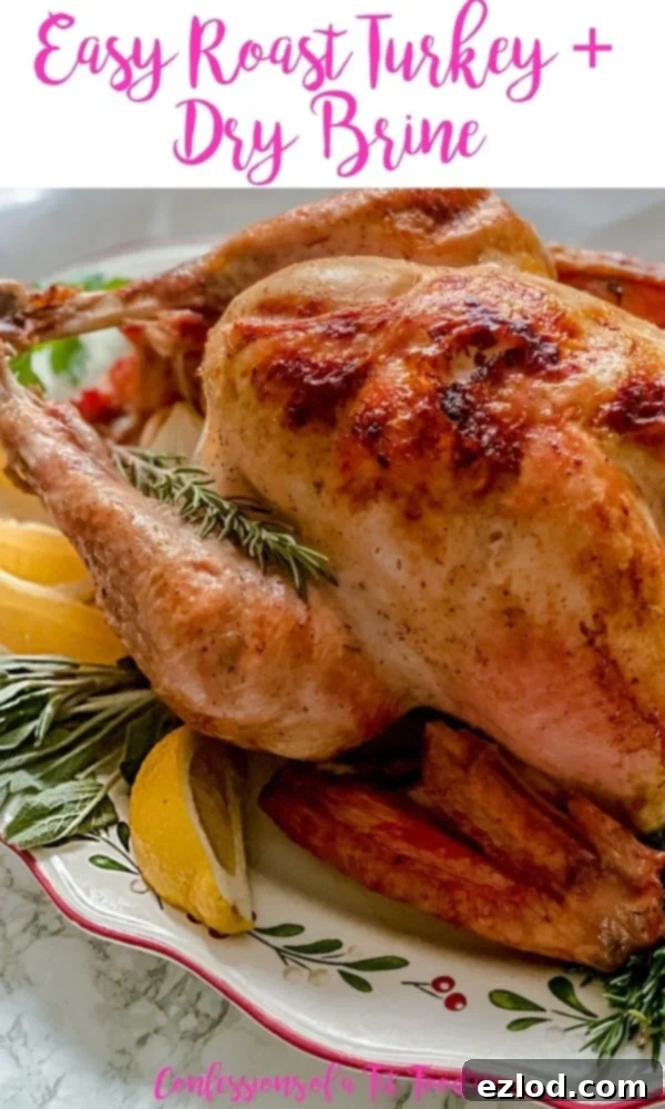 Close up photo of a whole turkey with pink text on a white rectangle. Text says, Easy Roast Turkey + Dry Brine | Confessions of a Fit Foodie, highlighting the recipe title and blog.