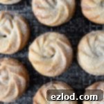 Top down shot of vegan Viennese whirl mince pies on a metal cooling rack.