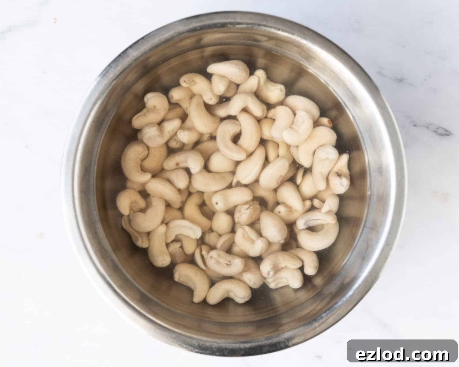 Step 1 - the cashews soaking in a metal bowl.