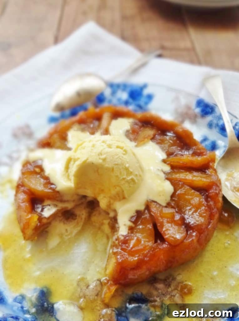 Beautifully inverted pear and ginger tarte tatin, showing the caramelized pears