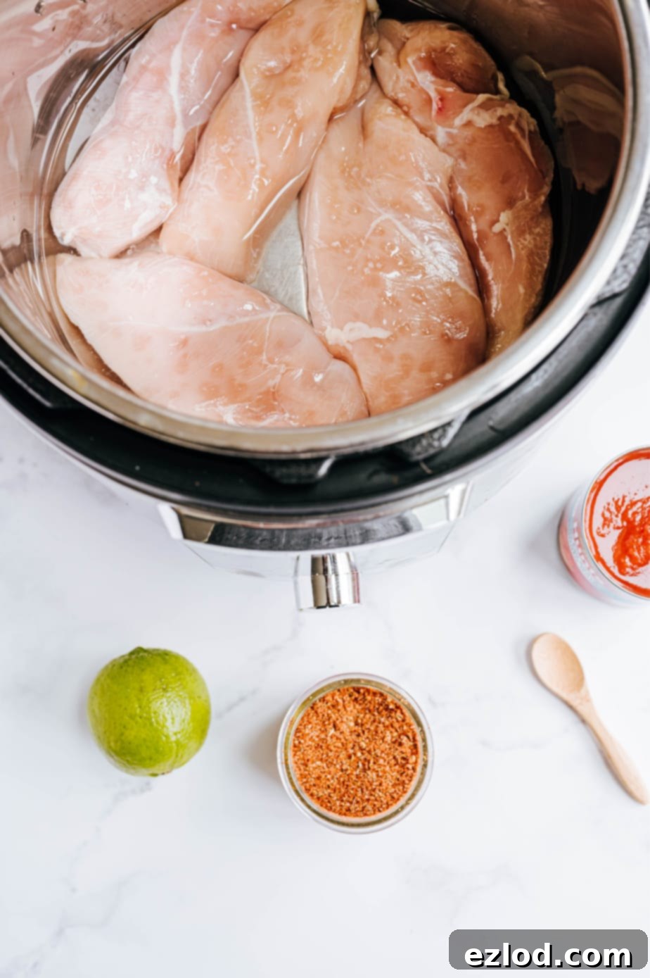 Ultimate Instant Pot Chicken Tacos 3 All the fresh and pantry ingredients for Instant Pot chicken tacos are neatly arranged on a clean white surface, ready for cooking.