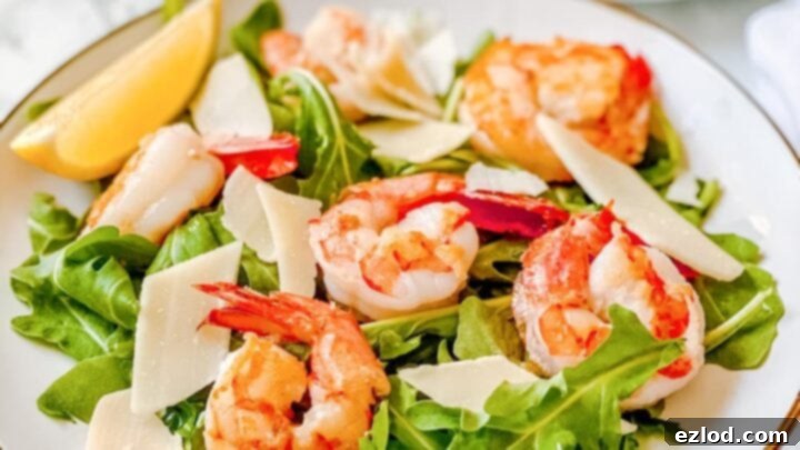 Fresh Lemony Arugula Salad topped with grilled shrimp.