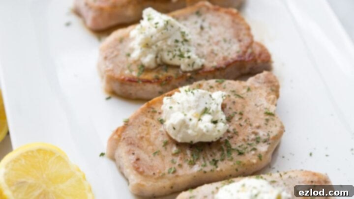 Juicy Pork Chops topped with a flavorful goat cheese butter.