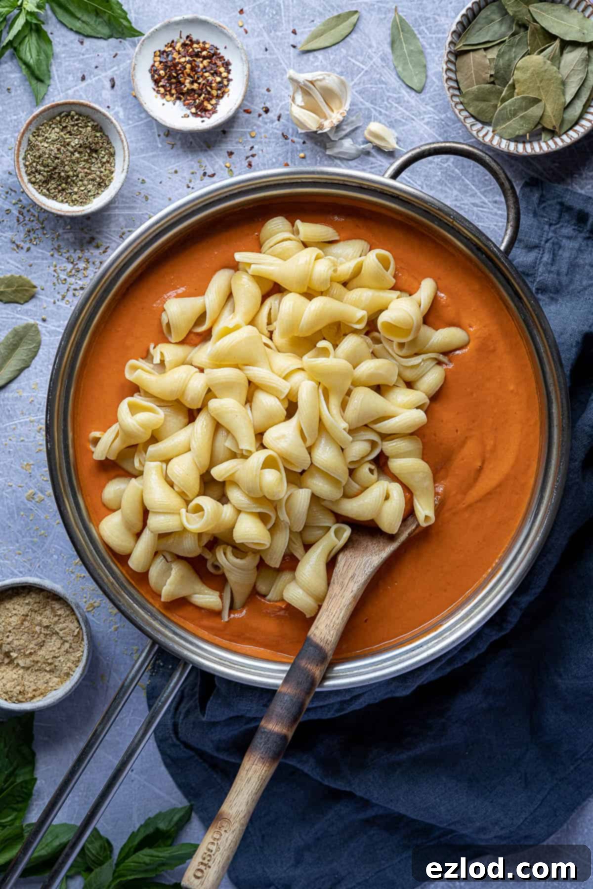 A large cooking pan filled with freshly prepared creamy vegan tofu tomato pasta sauce, ready to be tossed with hot pasta.