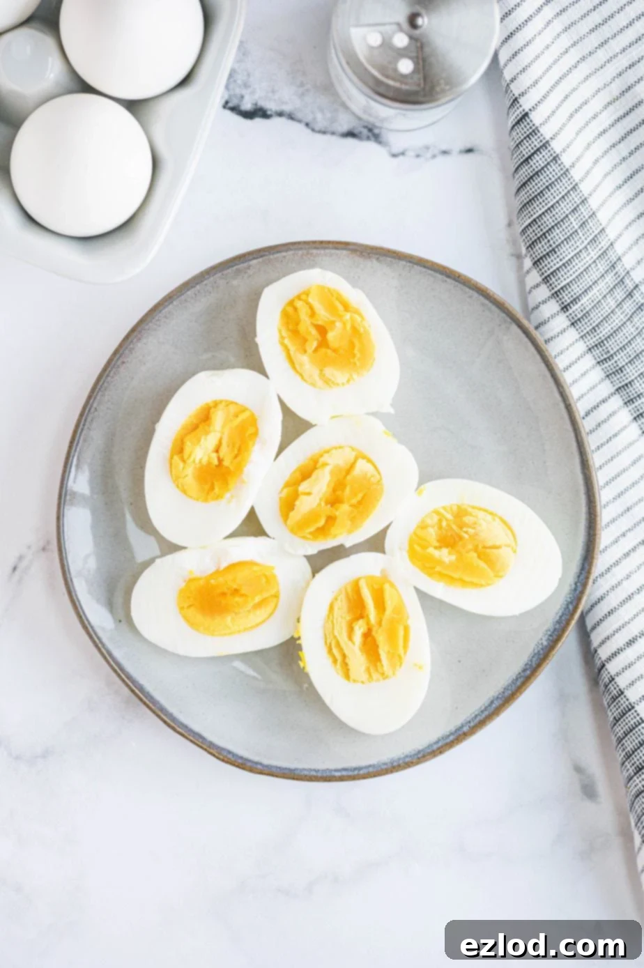 A plate is presented with 6 pieces of halved hard boiled eggs, perfectly cooked and ready to eat.