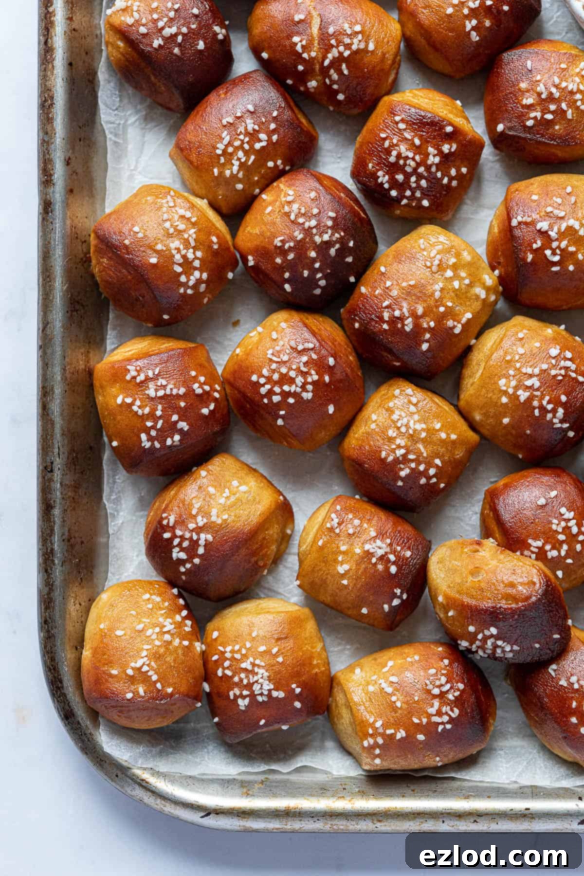 Close up of vegan pretzel bites on a metal tray.