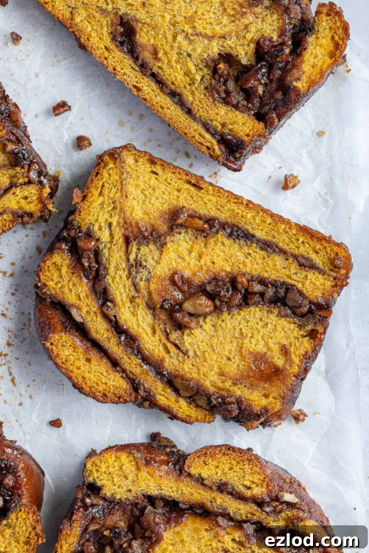 Close up of a slice of vegan pumpkin pecan babka.