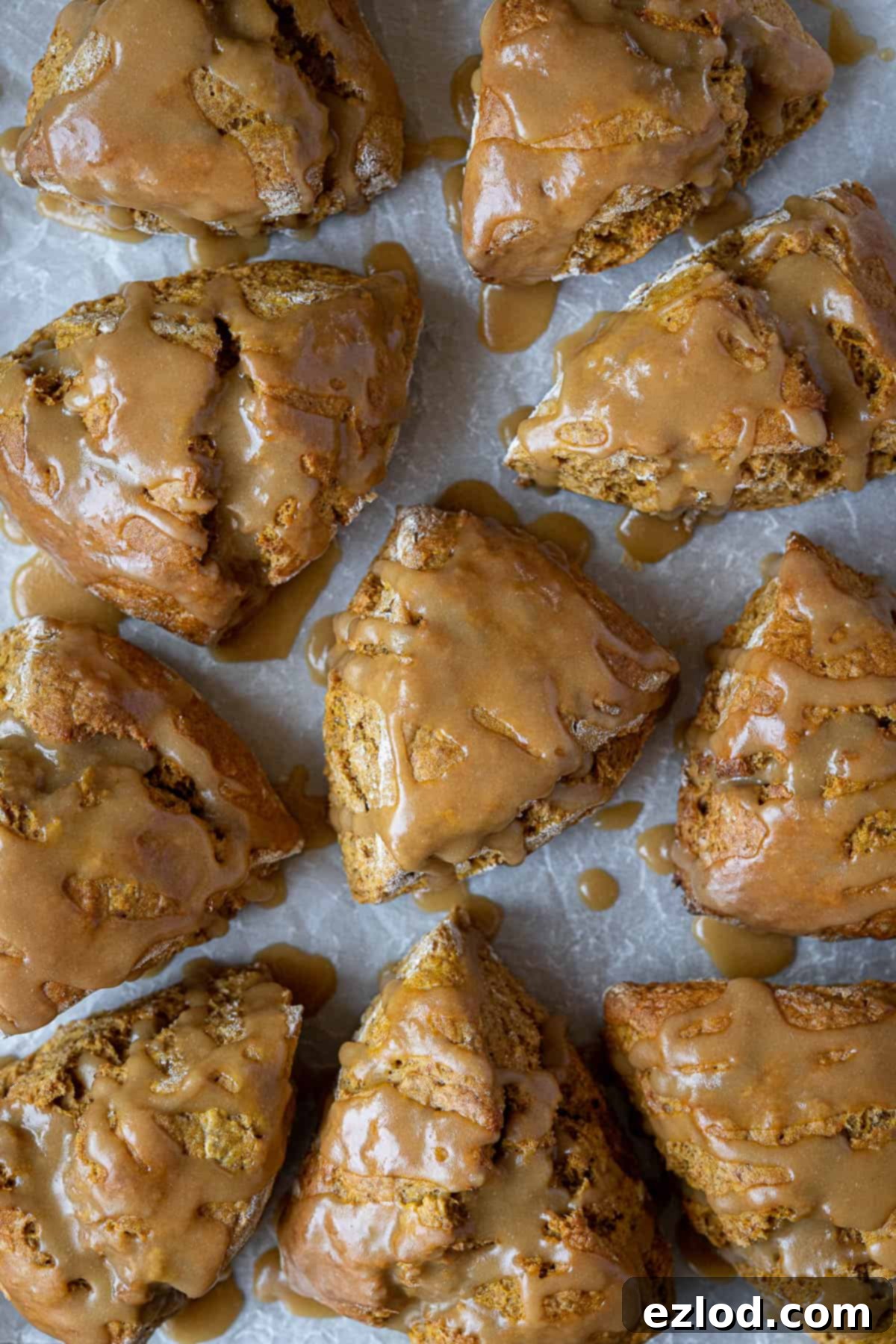 Close-up of a stack of fluffy vegan pumpkin scones, showing their moist texture and golden-brown tops.