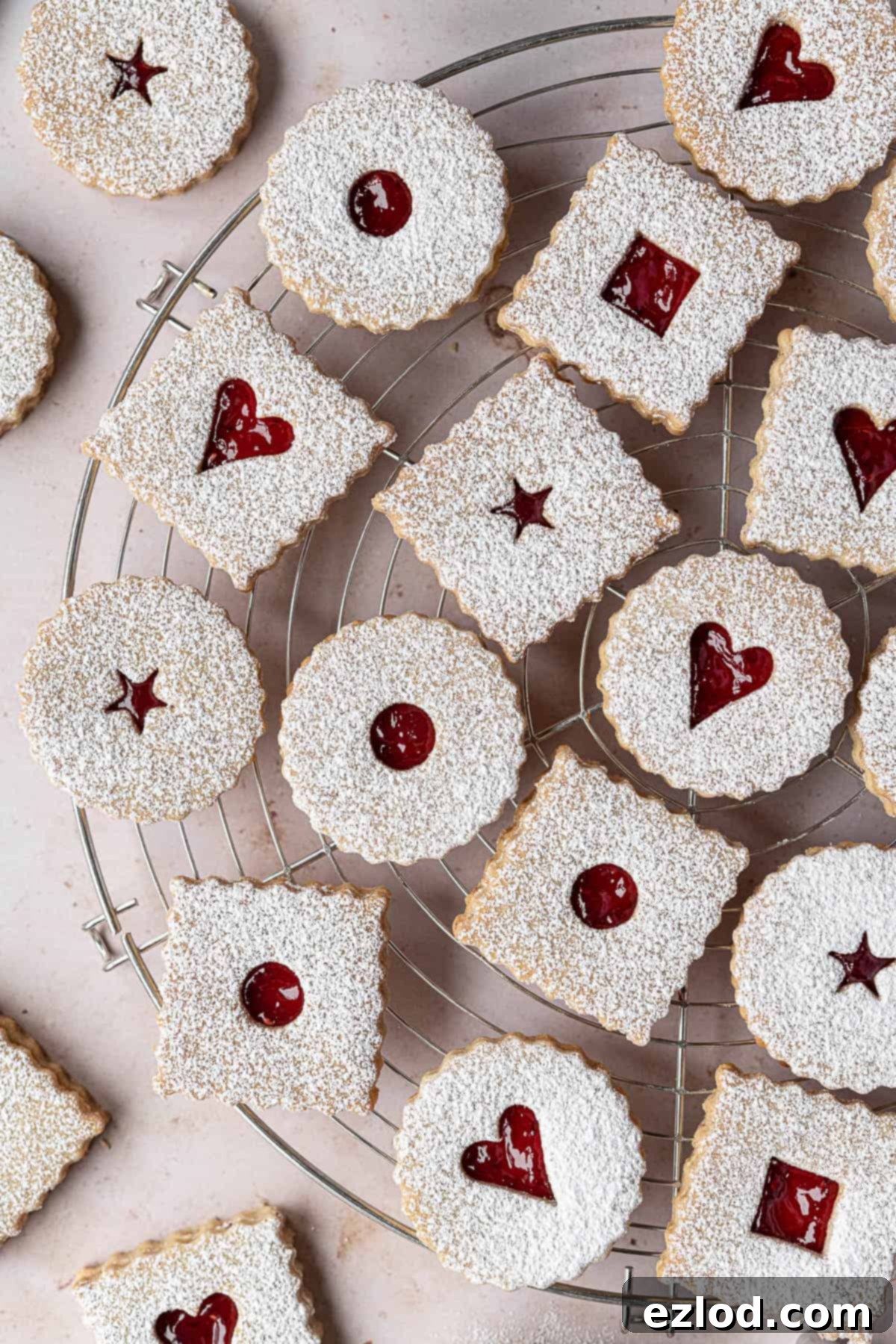 An inviting overhead shot of finished Linzer cookies arranged on a wire cooling rack, ready to be served or stored.