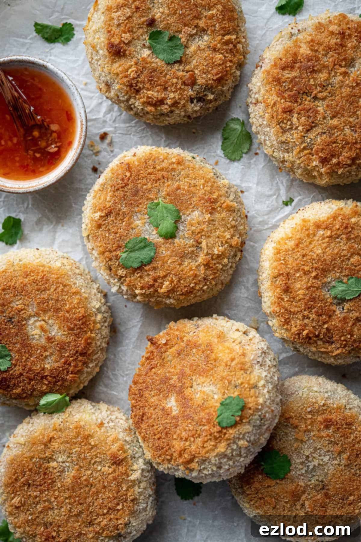 Close up of beautifully plated vegan Thai red curry fish cakes, showcasing texture and vibrant colors.
