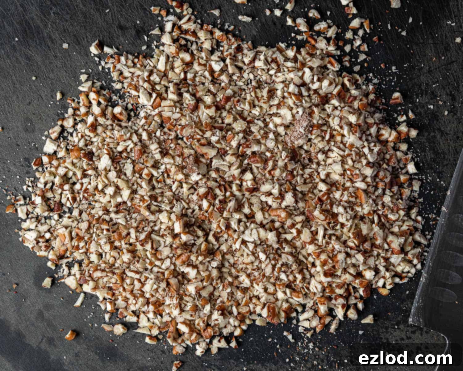 Classic Vegan Pecan Snowball Cookies 5 Step 1: Close-up of finely chopped toasted pecans, ready to be incorporated into the cookie dough.