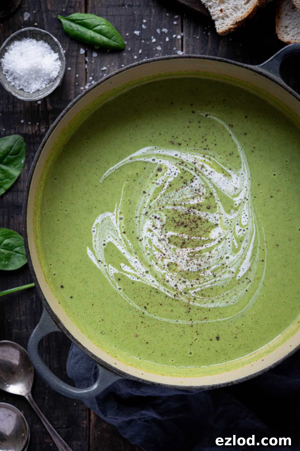 Creamy Vegan Broccoli Cheese Soup 3 A close-up view of a large pan filled with vibrant green cheesy vegan broccoli soup, simmering gently on a stovetop, capturing its inviting texture and rich color.