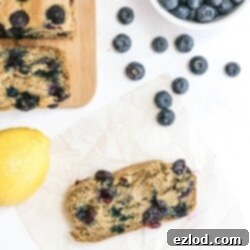 Beautifully baked Healthy Lemon Blueberry Bread, golden brown with visible blueberries, ready to be served.