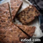 Sliced gluten free vegan Christmas cake on a metal tray.