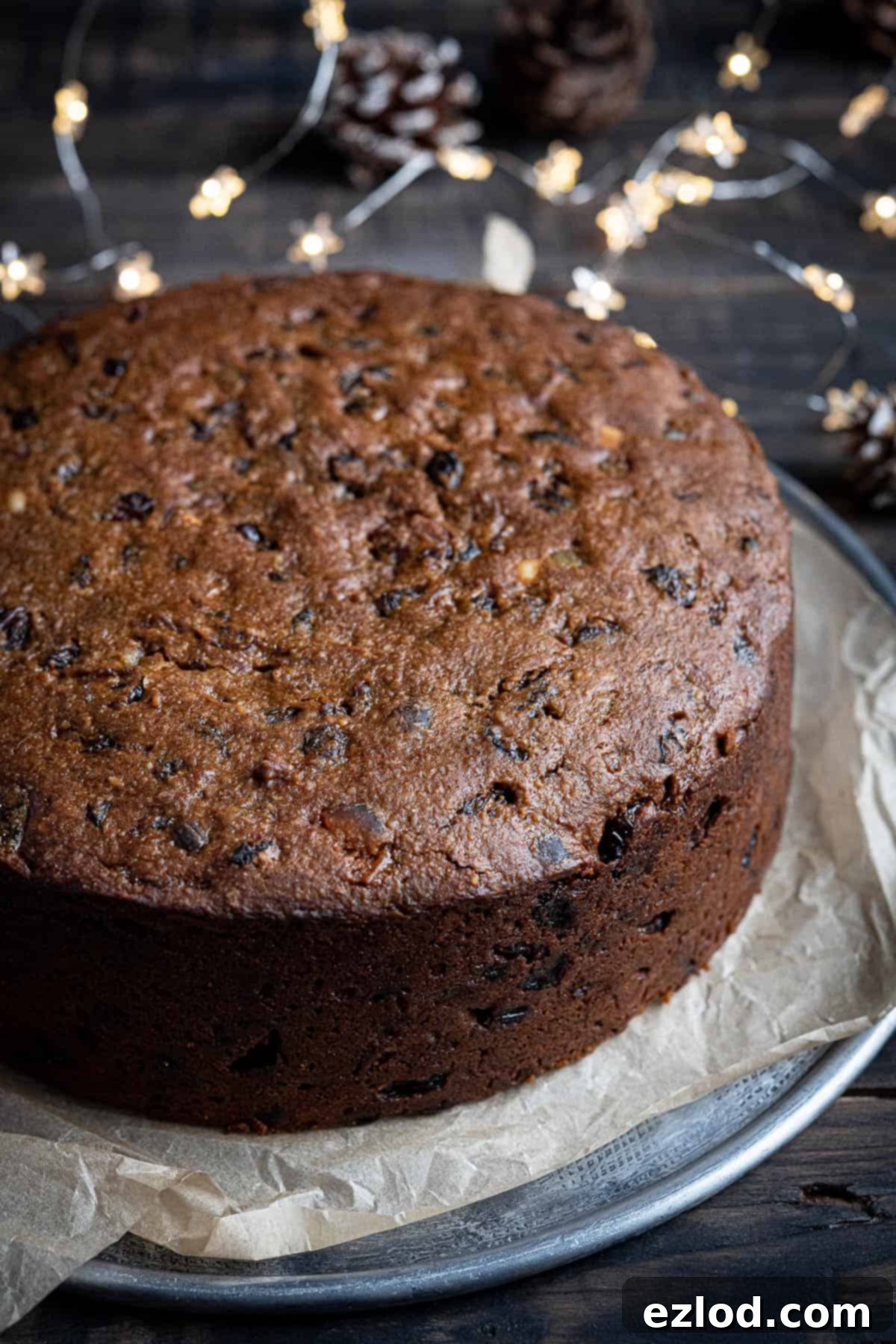 A close-up view of the perfectly baked gluten-free vegan Christmas cake, showing its rich, dark surface.