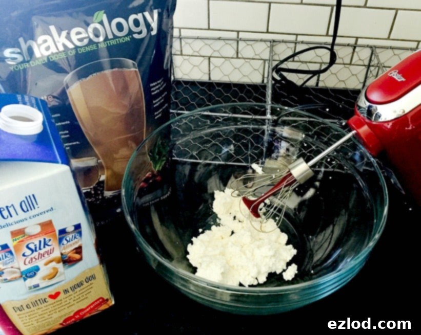 A bowl of freshly whipped ricotta, showcasing its light and airy texture perfect for a healthy dessert base.