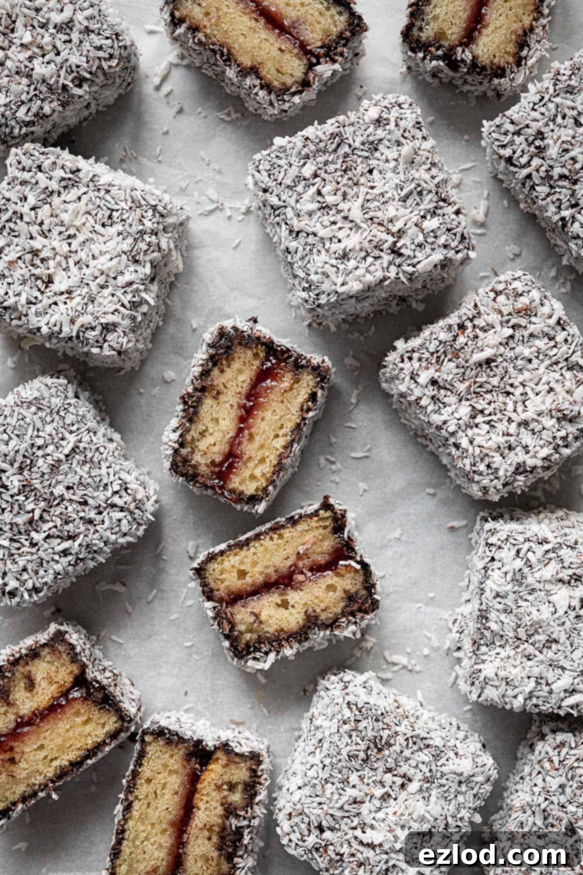 Close up of vegan lamingtons, some sliced in half.