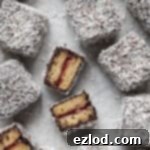 Close up of vegan lamingtons, some sliced in half.