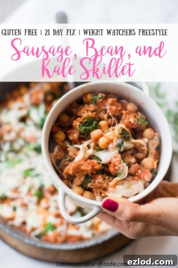 An appetizing overhead view of the Healthy Sausage, Bean, and Kale Skillet, fully cooked and topped with melted cheese, showcasing its vibrant colors and inviting texture. Ideal for 21 Day Fix and Weight Watchers.