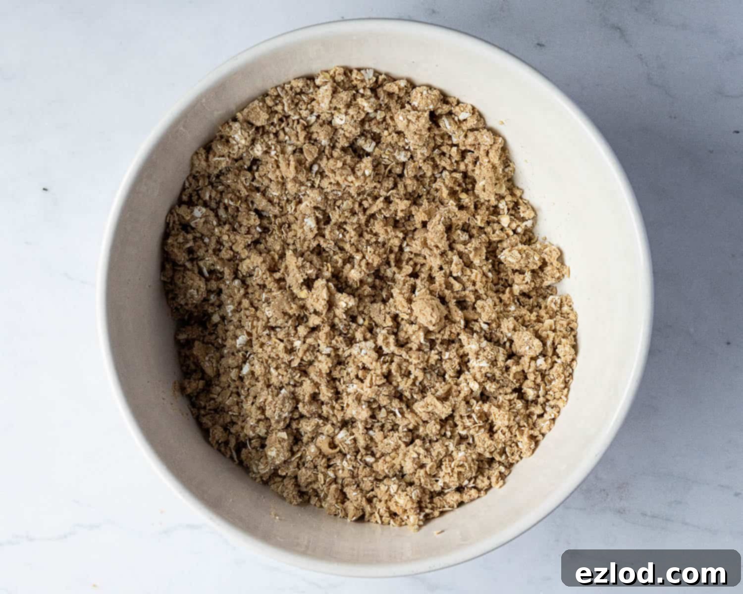 Vegan Mincemeat Crumb Bars 5 Step 2 in making mincemeat crumble bars: the cold vegan butter has been rubbed into the dry ingredients, forming a mixture that resembles coarse breadcrumbs.