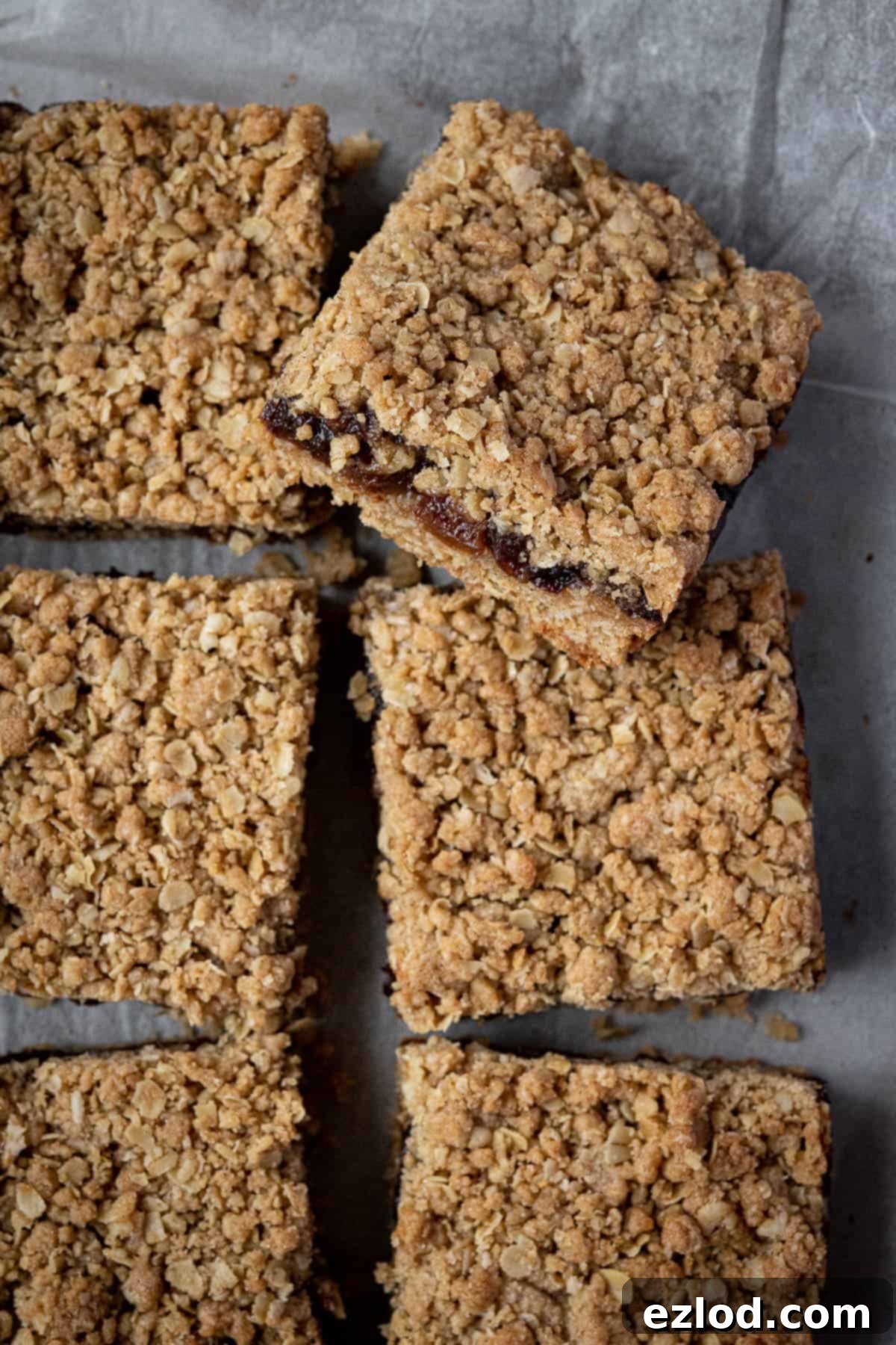 Vegan Mincemeat Crumb Bars 9 A close-up shot of a single vegan mincemeat crumble bar, highlighting the crumbly texture of the topping, the rich mincemeat filling, and the sturdy oat base.