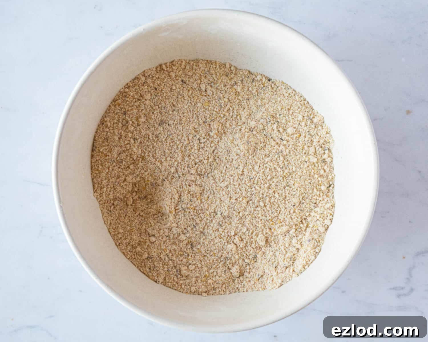 Step 3: The dry ingredients mixture after the butter has been fully rubbed in, showing a fine, even breadcrumb texture with no large lumps of fat.