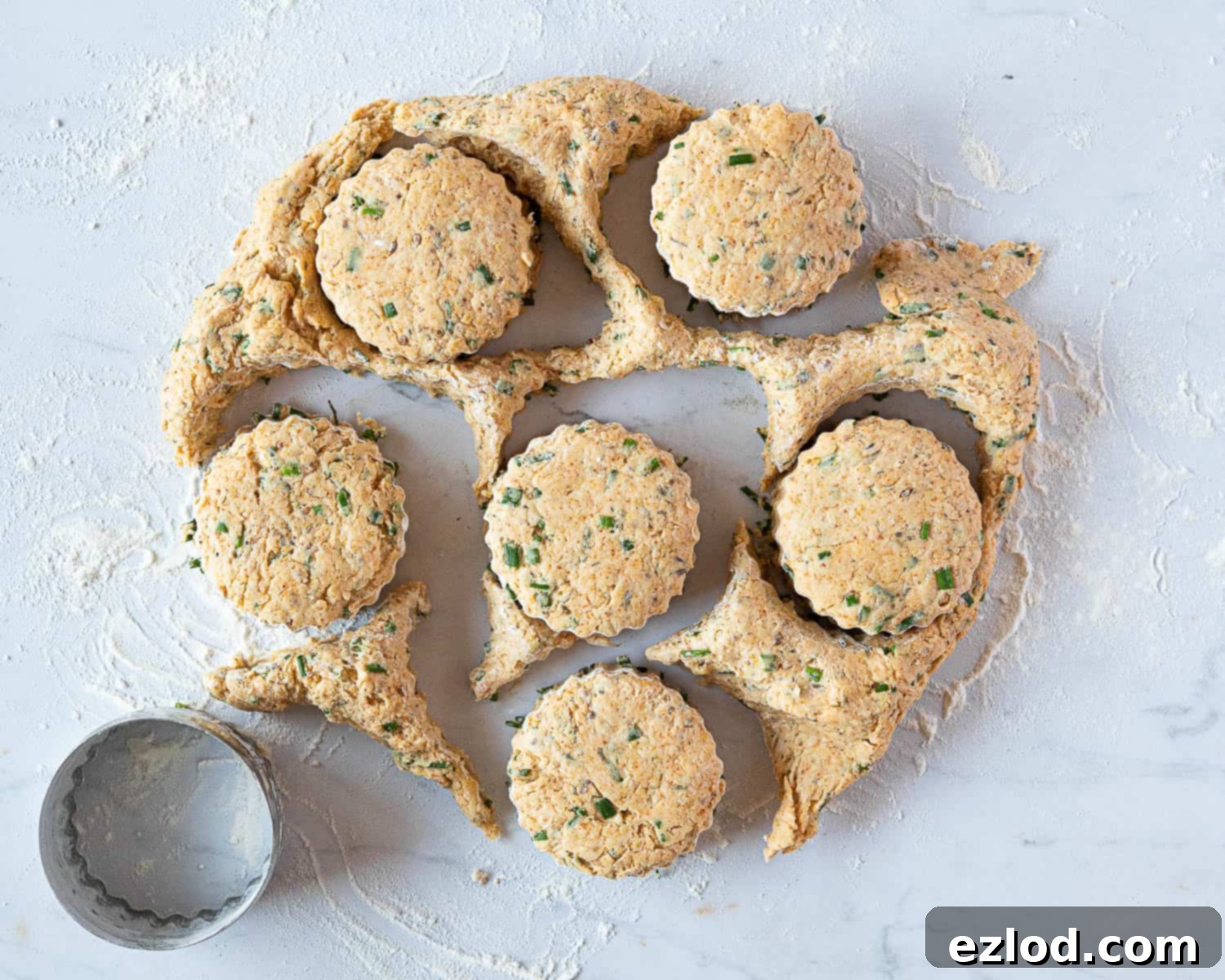 Step 7: Cutting out round savoury vegan scones from the patted-out dough using a floured round cutter.