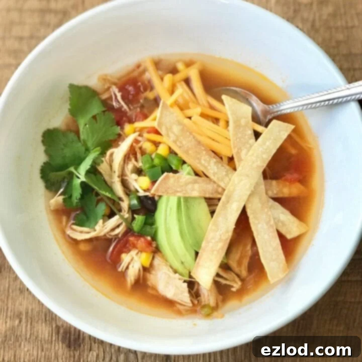 Bowl of Instant Pot Chicken Tortilla Soup topped with cilantro and avocado