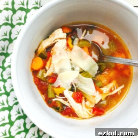 Bowl of Easy Chicken Veggie Soup with chicken, carrots, celery, and spinach.