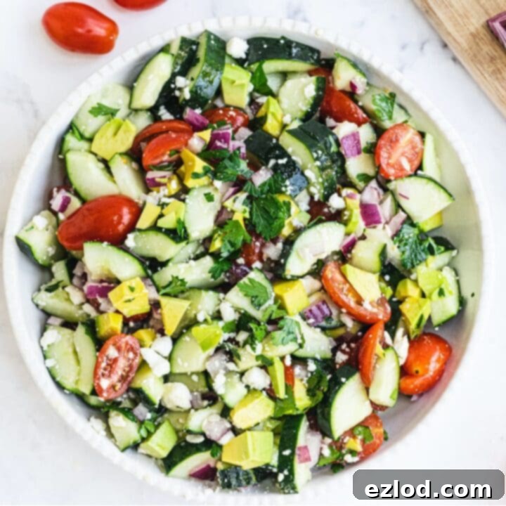 Vibrant Cucumber Tomato Salad with Avocado and Feta cheese.