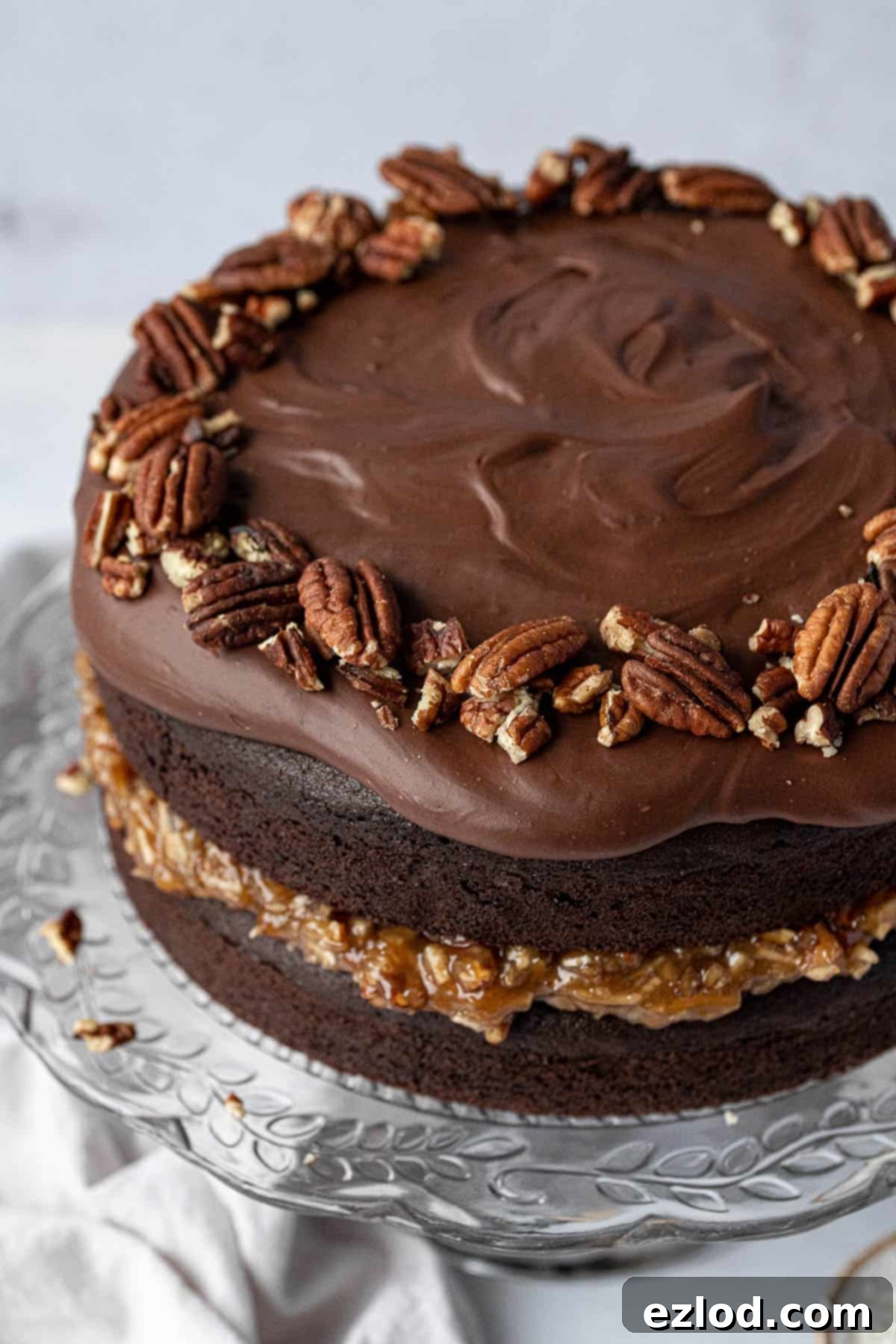 Close up of German chocolate cake topped with pecans.