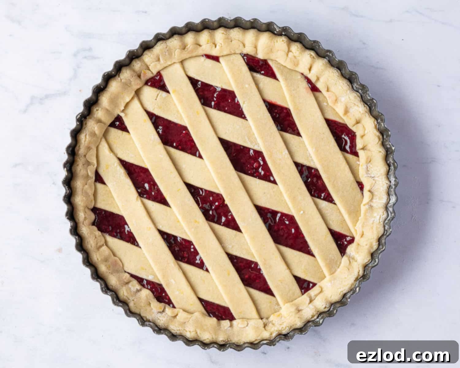 The fully assembled vegan crostata with its neatly sealed lattice top, showcasing the perfect readiness to be chilled and then baked to a golden perfection.