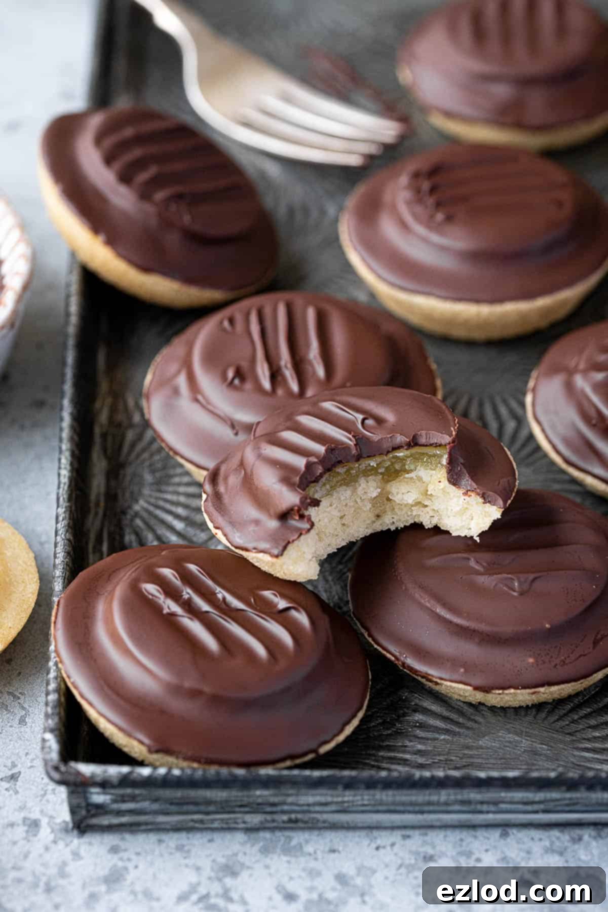 Close up of vegan jaffa cakes, one with a bite taken out of it.