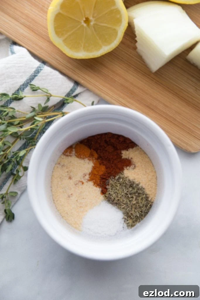 Close-up of the dry spice rub for chicken, showing the mixture of paprika, cayenne, onion powder, thyme, garlic powder, and salt