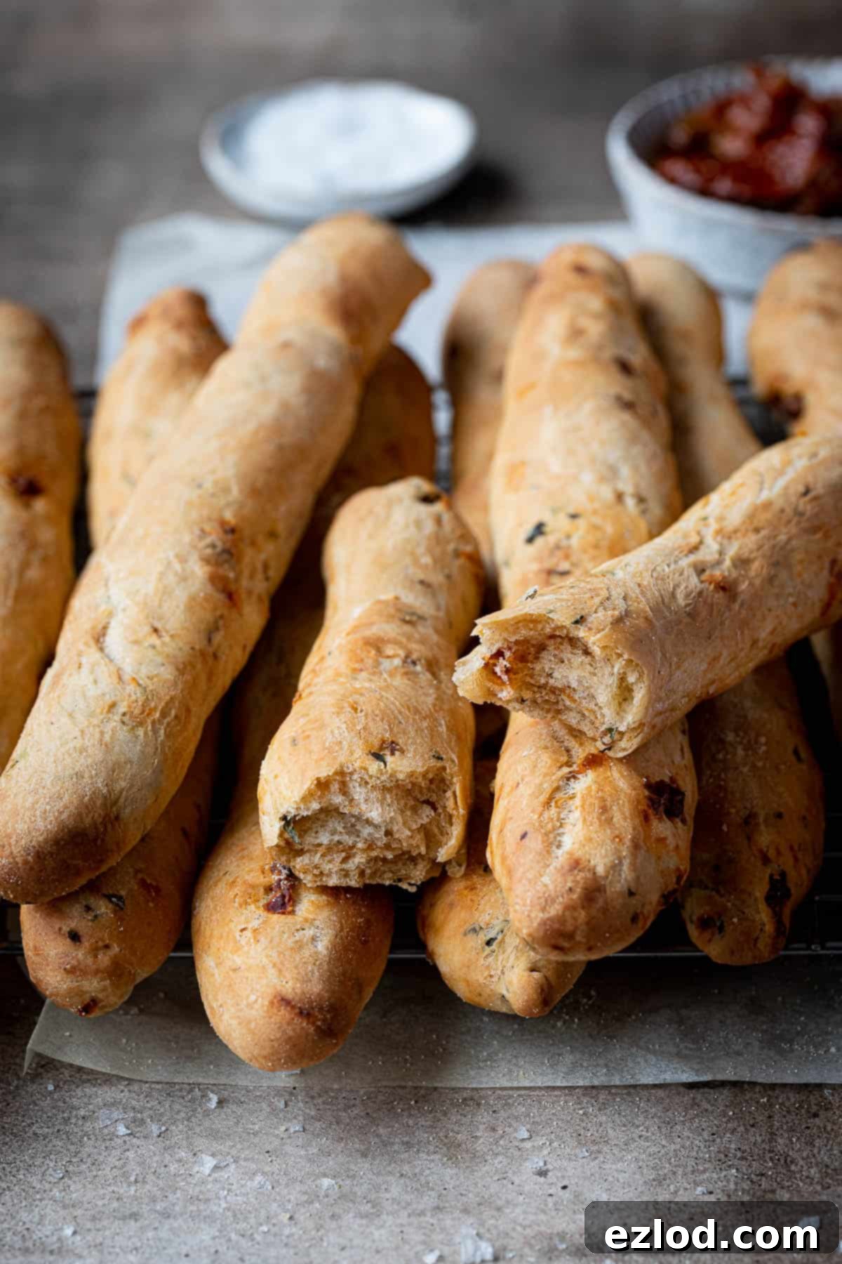 Artisan Sun Dried Tomato Breadsticks 3 Close up of a sun dried tomato breadstick broken in half.
