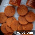 Close up of slices of seitan pepperoni.