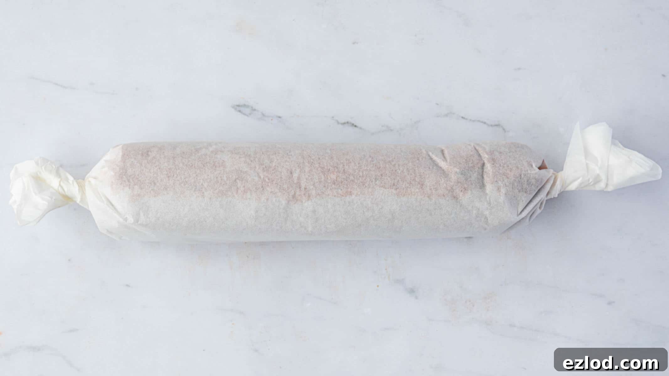 Step 5, the log rolled in baking parchment.