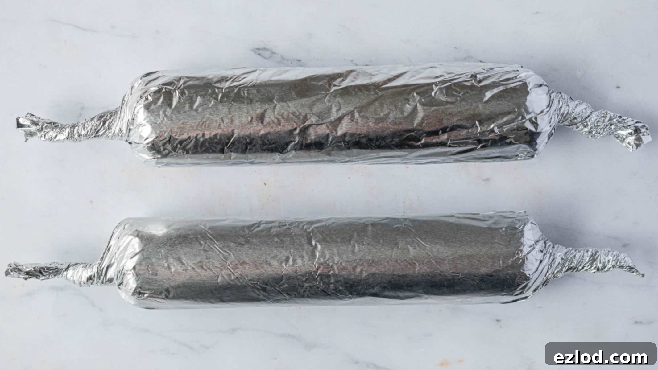 Step 6, the seitan logs rolled in tin foil.