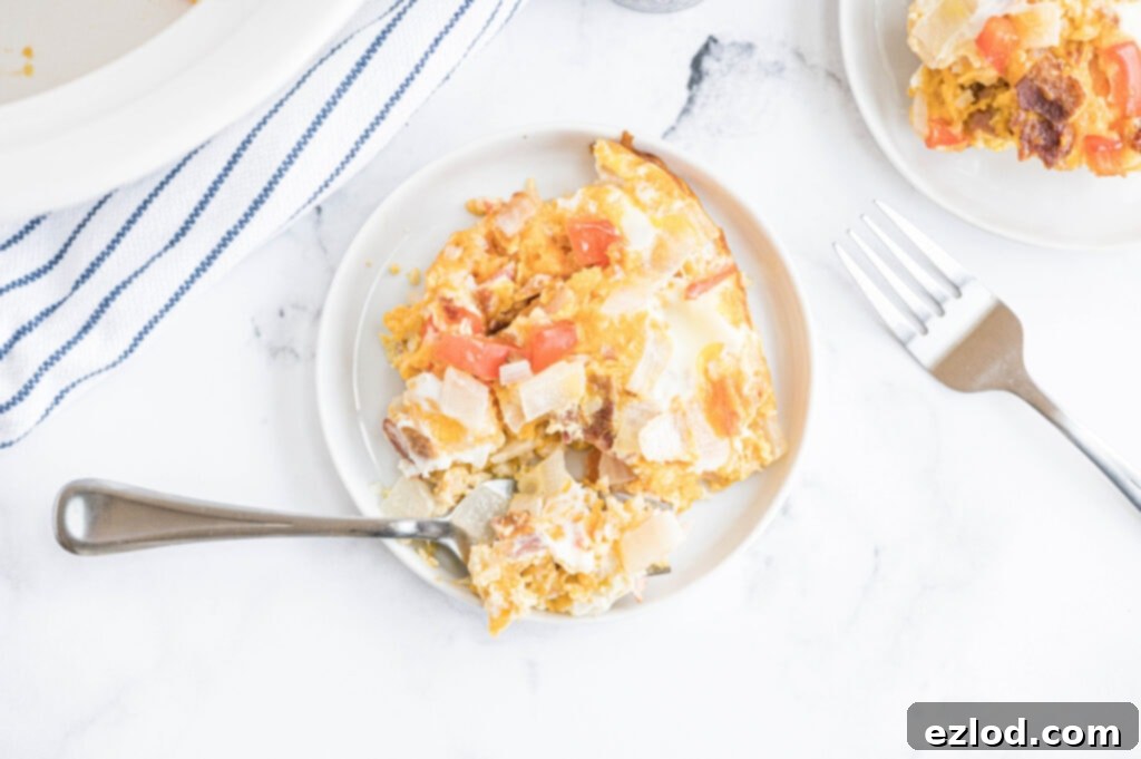 Two plates of low carb egg casserole served on a white table, ready to eat