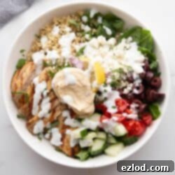 Mediterranean Bowl with chicken, hummus, veggies, and tzatziki dressing.