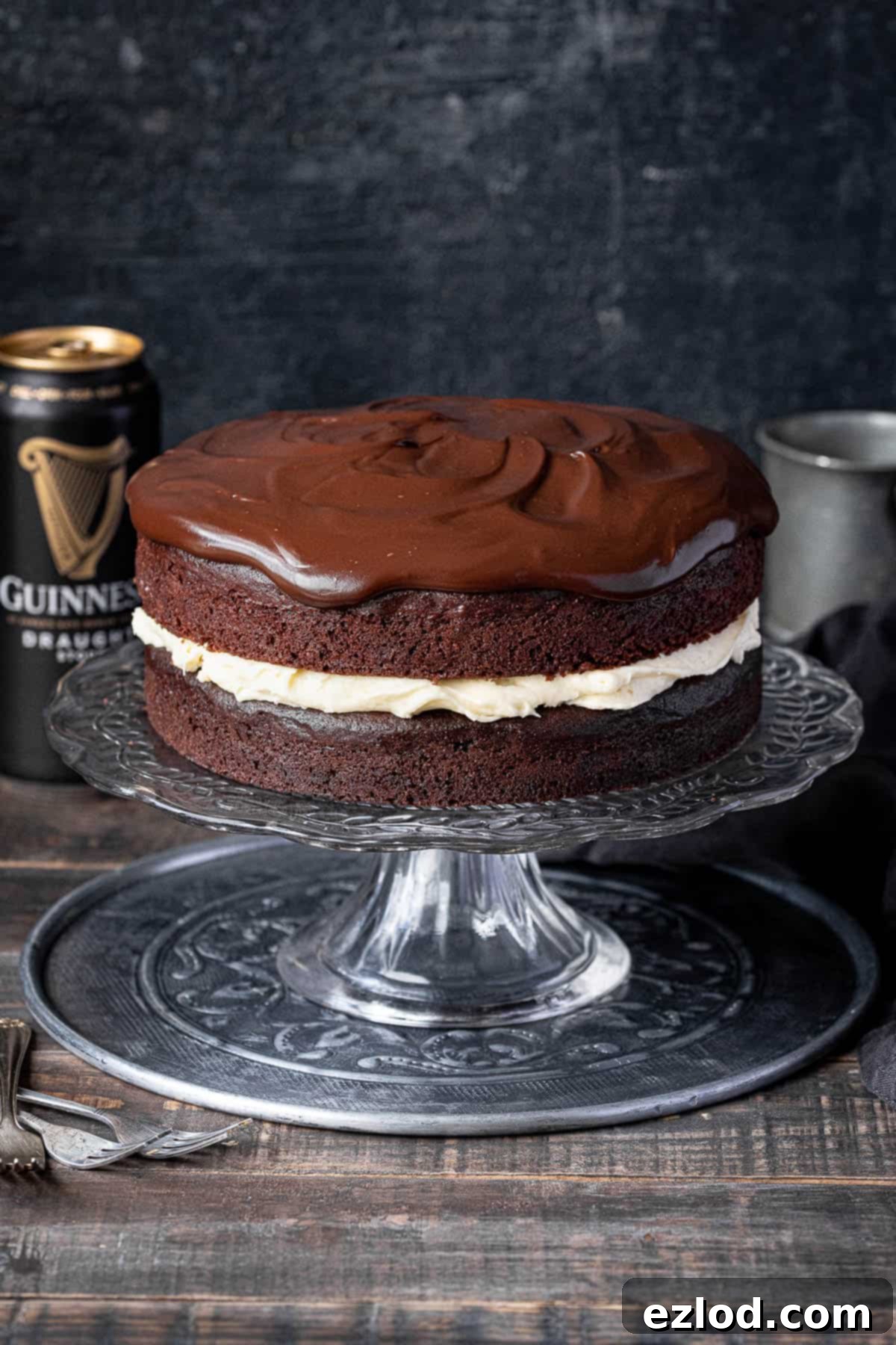 Vegan Guinness chocolate cake on a cake stand with a can of Guinness.
