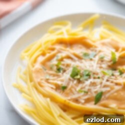 Healthy Pumpkin Alfredo Sauce served with fettuccine pasta.