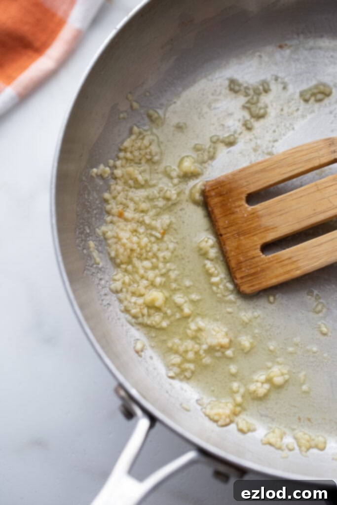 Garlic and butter sizzling in a pan for the start of the Alfredo sauce.