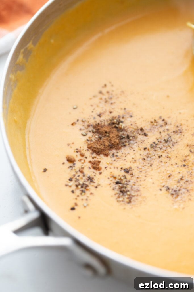 Cheese melting into the thickened sauce, creating a creamy texture.