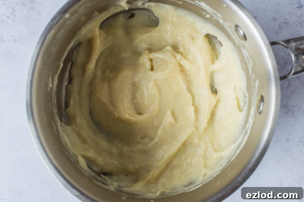 A close-up shot of the tangzhong mixture in a saucepan, showing its thick, paste-like consistency.