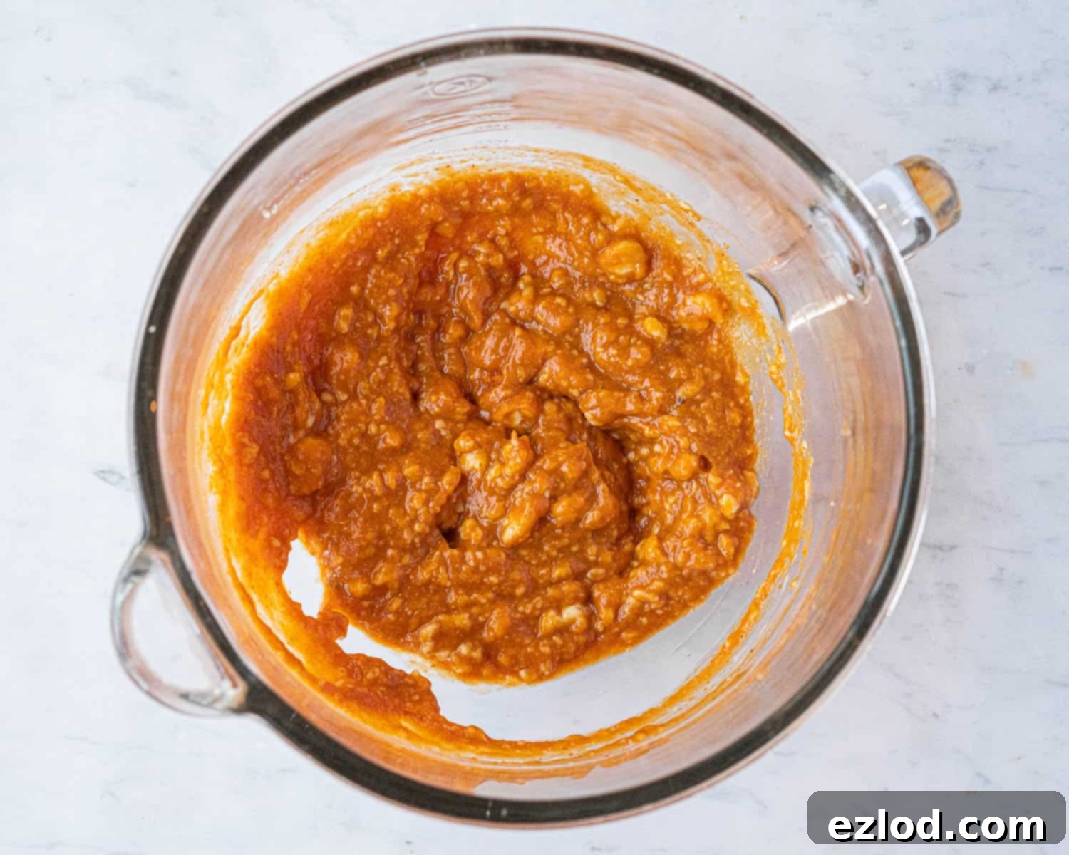 The liquid ingredients, including tangzhong, pumpkin puree, milk, and sugar, mixed in a stand mixer bowl.
