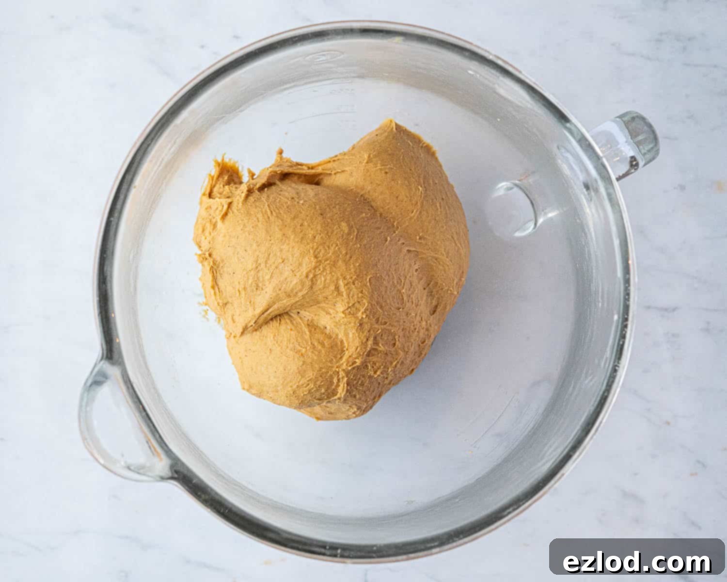 The perfectly kneaded dough, smooth and elastic, pulling away from the sides of a stand mixer bowl.