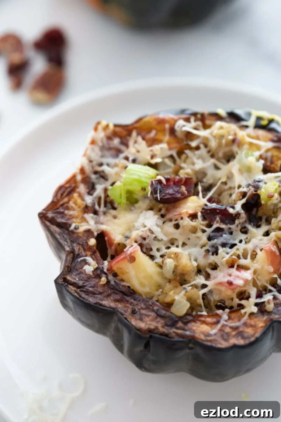 Acorn squash stuffed with sausage, quinoa, apple, celery, and cranberries then topped with shredded cheese and cooked in the Air Fryer.