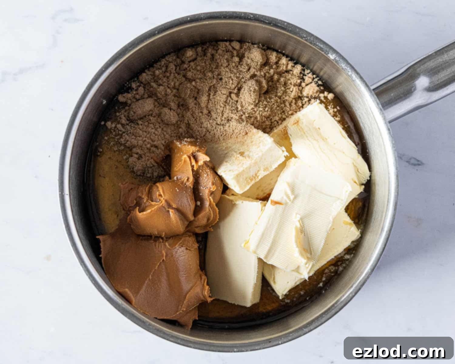 Step 2: Wet ingredients (vegan butter, Biscoff, brown sugar, golden syrup) melting in a pan over low heat.