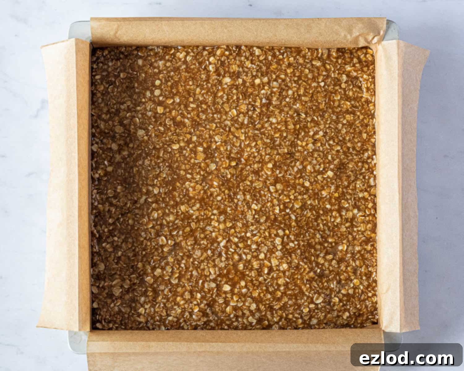 Step 3: The flapjack mixture pressed firmly and evenly into the lined cake tin.